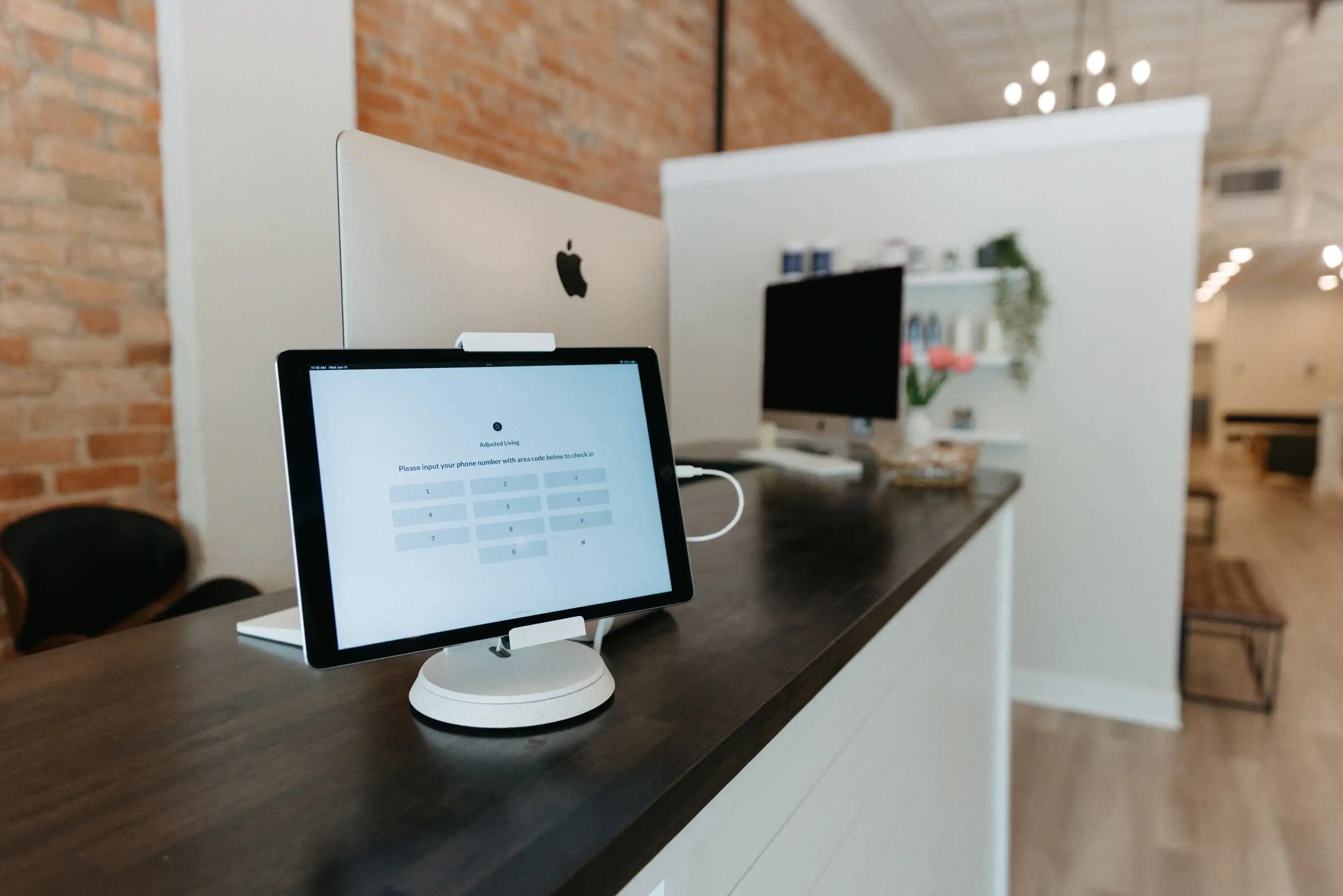 Photo of a tablet at a receptionist desk for when to see a chiropractor
