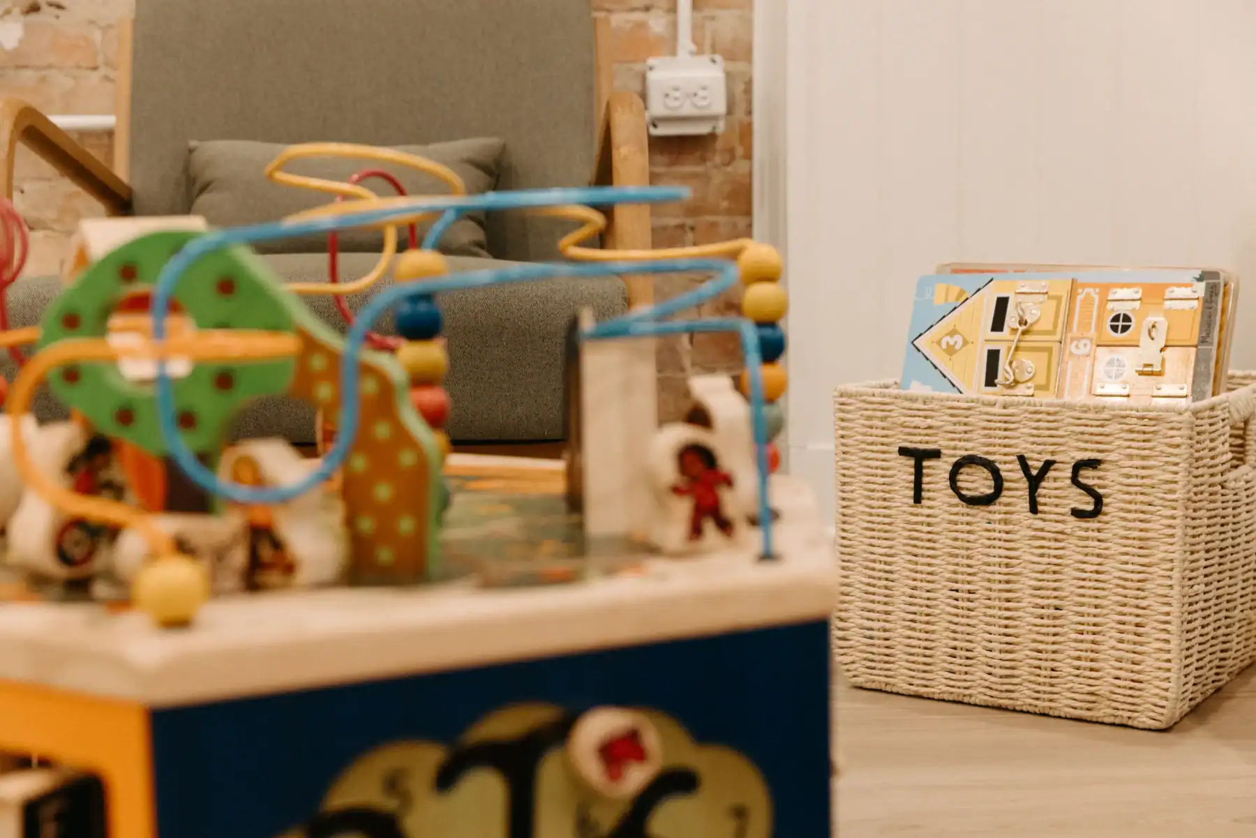 photo of kids toys on a table and in a basket in a living room area