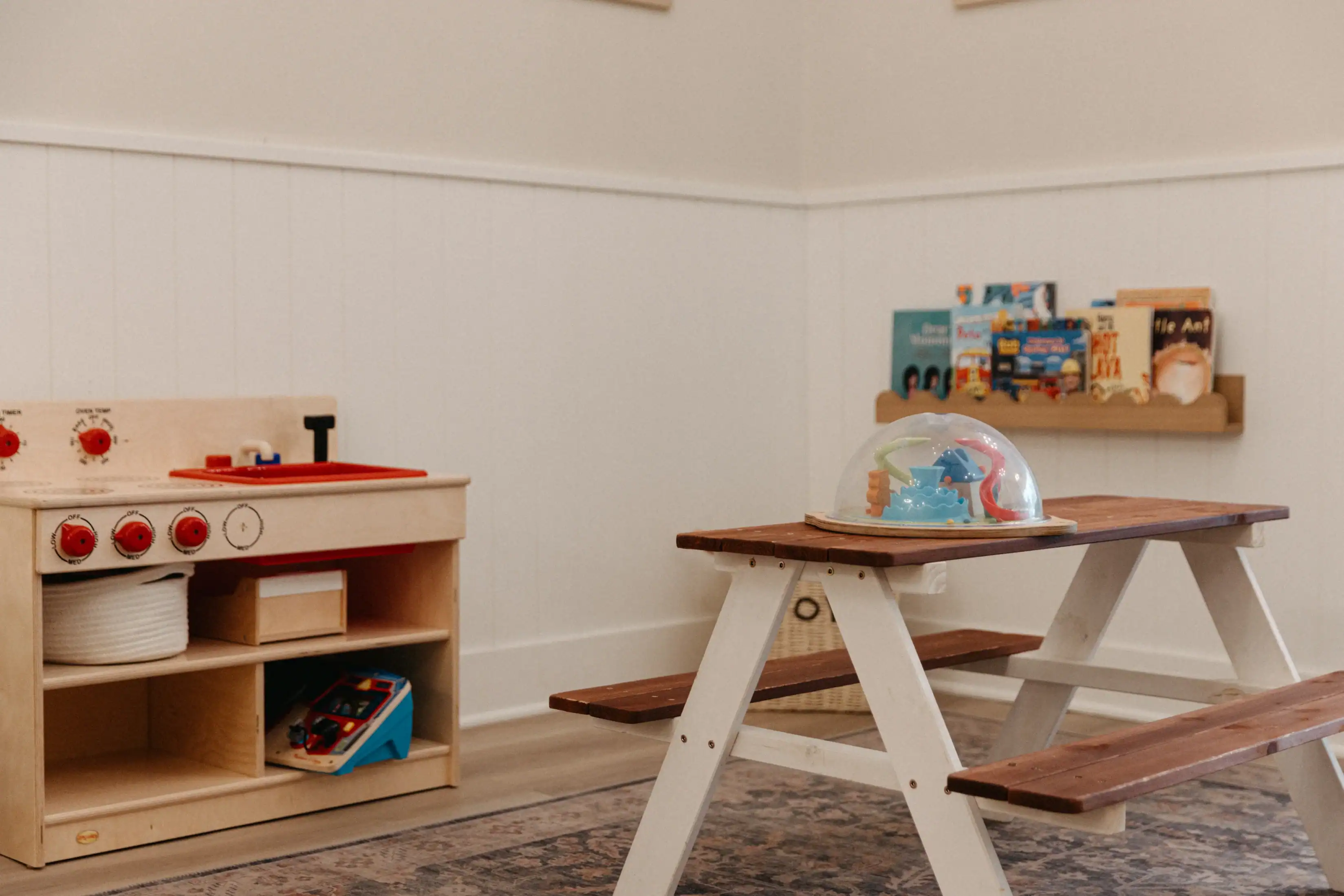 photo of sensory activities for toddlers in a kids play area with a picnic table and toys